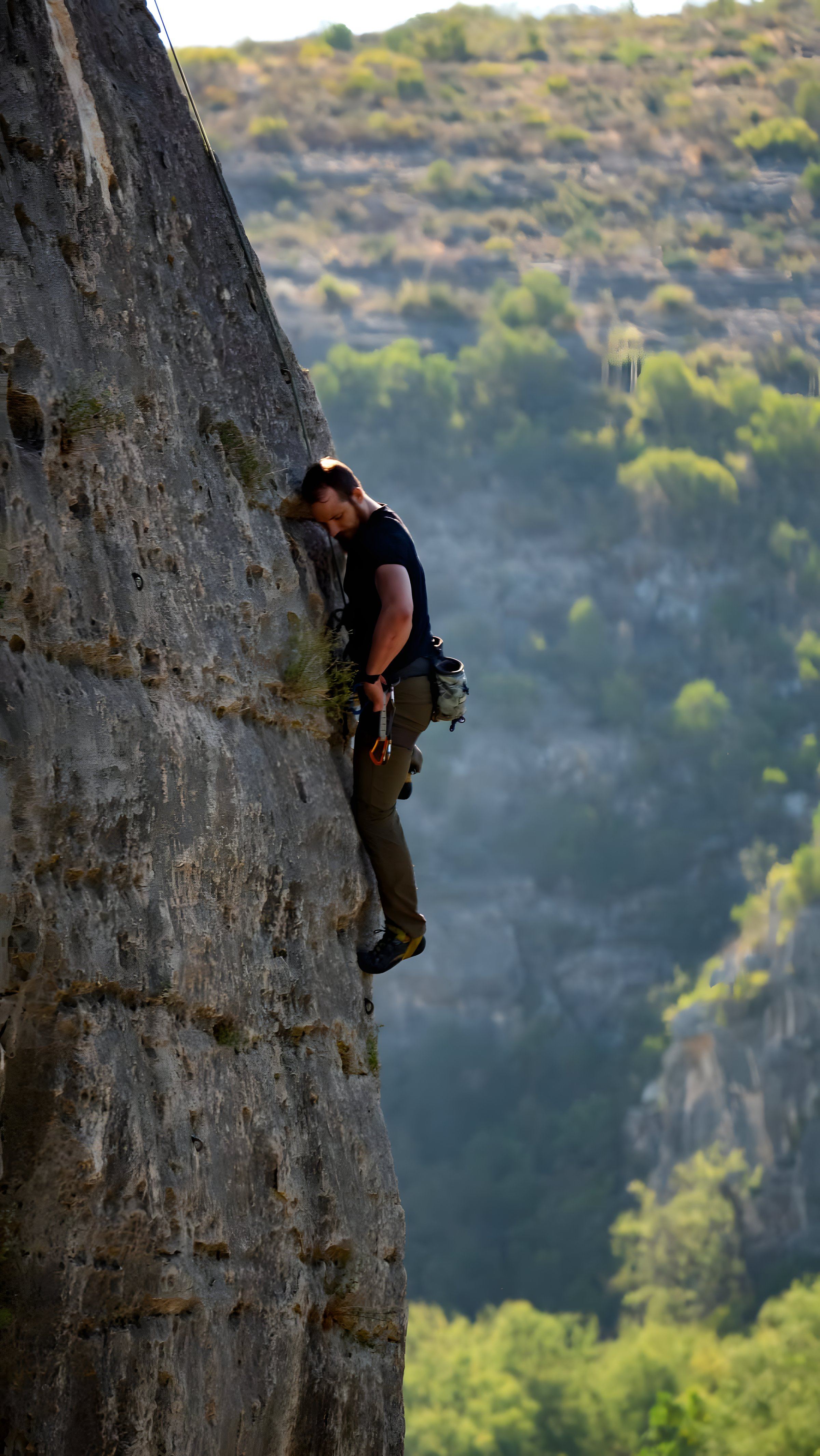 Benjamin Higgins rock climbing a steep face