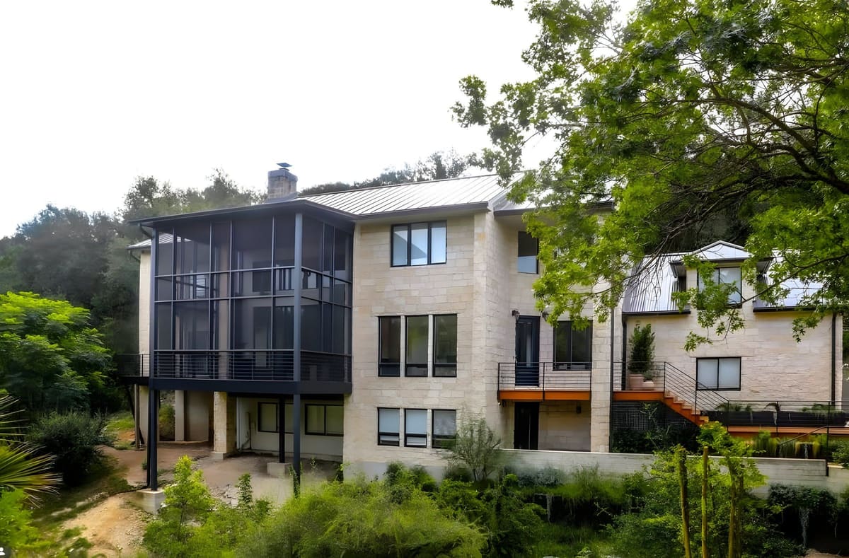 Sugar Creek Addition — A limestone hillside addition with a screened glass volume — engineered to sit lightly above the pool terrace.