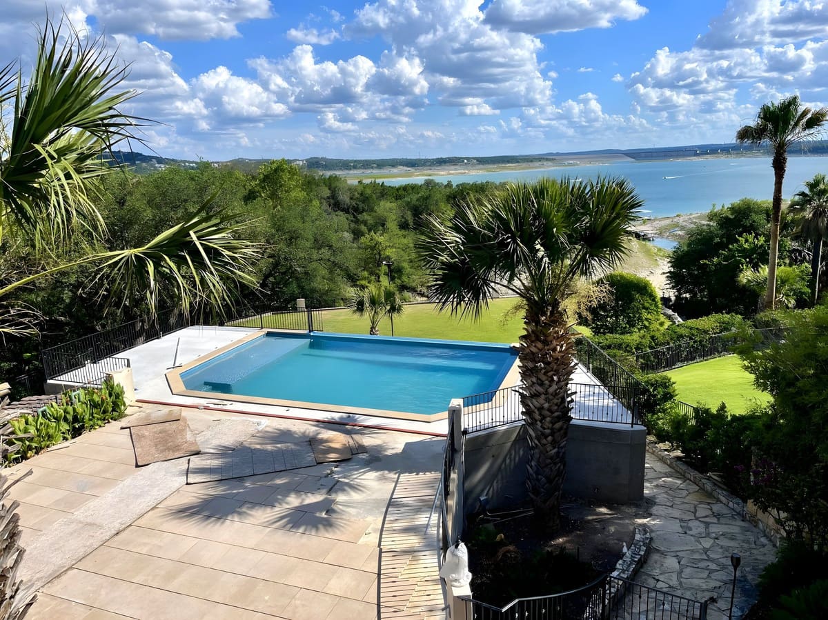 Lake Travis Pool — A hillside pool and terrace overlooking Lake Travis, engineered to hold water, terrace, and view on a sloped site.
